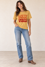 Woman wearing the Dolly Vibes retro country graphic tee in mustard